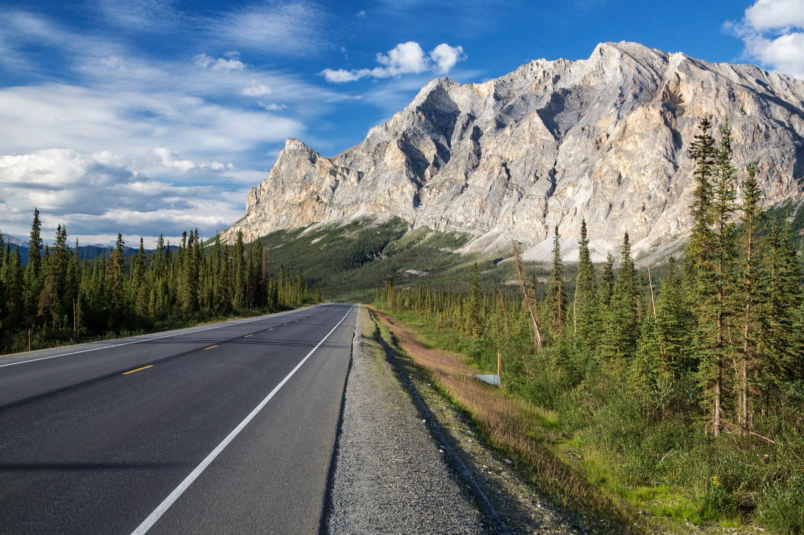 The Dalton Highway running past the limestone face of Sukakpak Mountain, north of Coldfoot