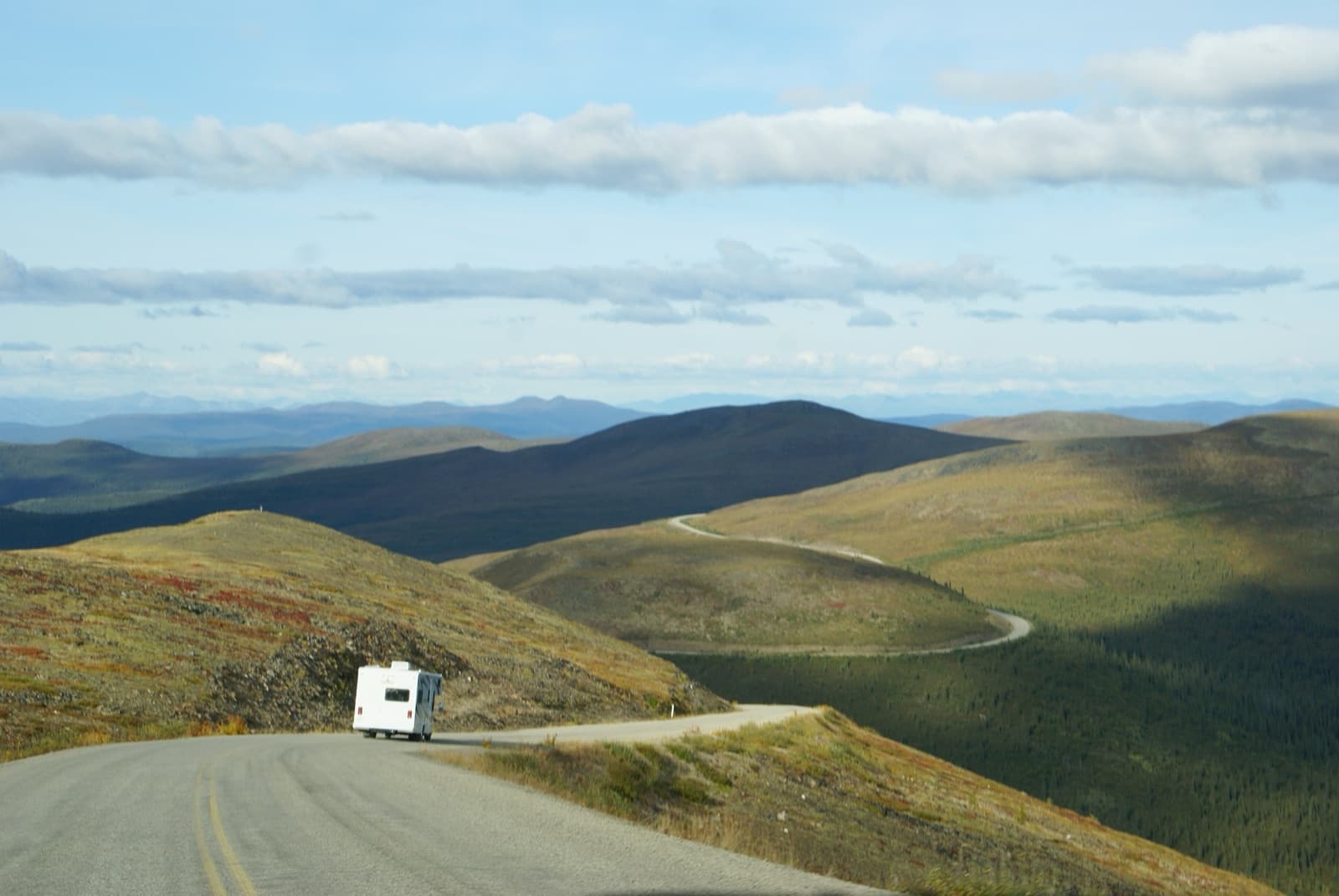 An RV following the winding ridge-top Top of the World Highway between Dawson City and Chicken