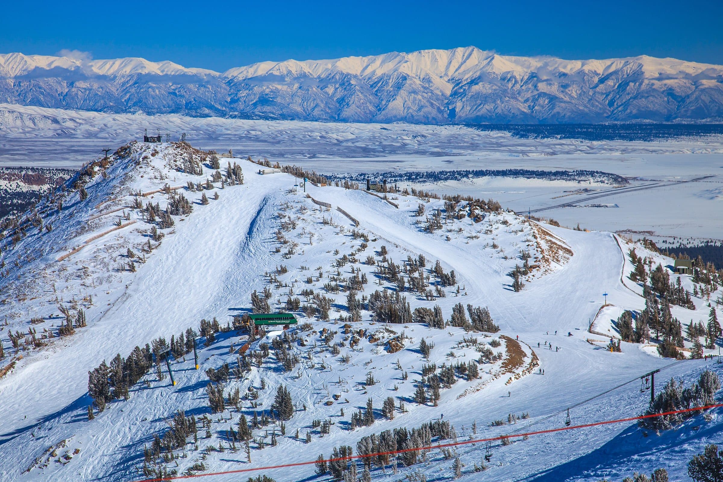 Groomed runs and lifts on Mammoth Mountain above the snow-covered White Mountains in February